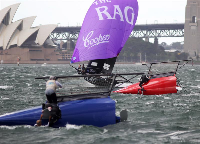 Rag and Famish Hotel passes the capsized Smeg and Yandoo photo copyright Frank Quealey taken at Australian 18 Footers League and featuring the 18ft Skiff class