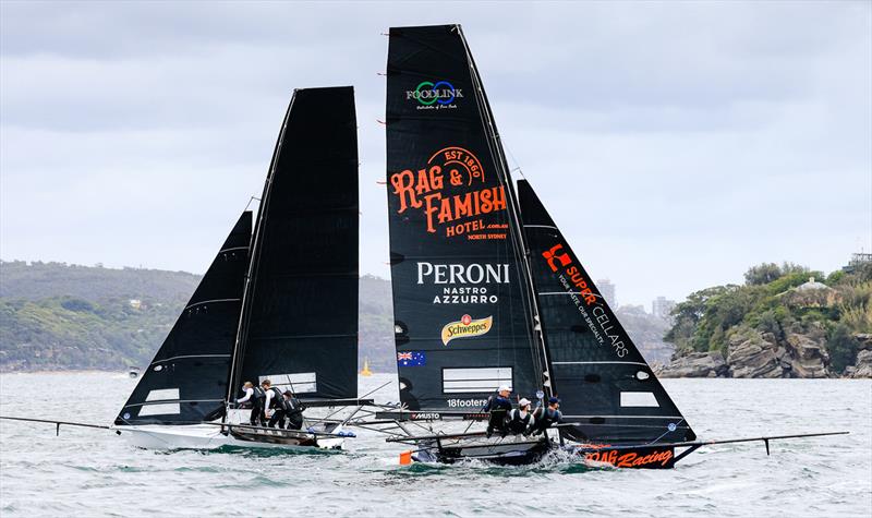 The unsponsored 'Put Your Name Here' heads the fleet at the first windward mark as Rag and Famish Hotel is still on the wind during race 5 of the 18ft Skiff Spring Championship 2023 photo copyright SailMedia taken at Australian 18 Footers League and featuring the 18ft Skiff class