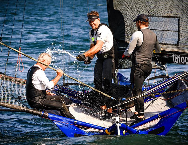 A champagne spray for Woody after winning the NSW Championship last Sunday photo copyright SailMedia taken at Australian 18 Footers League and featuring the 18ft Skiff class