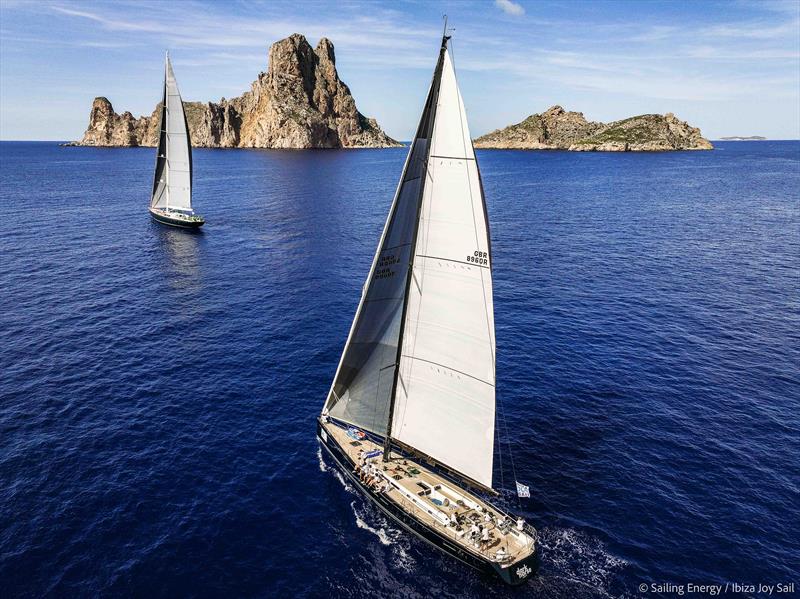 Ibiza JoySail Day 2: Black Horse and Scorpion of London with the islet of Es Vedrà in the background photo copyright Sailing Energy taken at  and featuring the Superyacht class