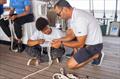 Asiphe Ganiso learning essential seafaring knots © Merlo Fotografia