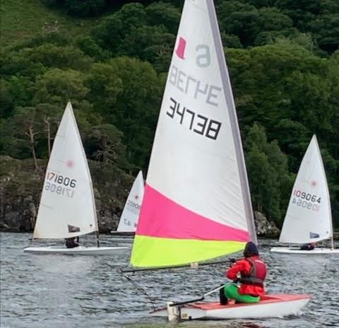 UYC boats sail past the Birkett plaque on Kailpot Crag photo copyright Andrew Bailey taken at Ullswater Yacht Club and featuring the Topper class