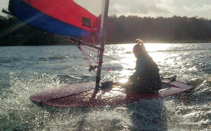 Rebecca Shearer making waves on a downwind finish in the STRA Schools Sprints at Linlithgow Loch photo copyright Peter Collings taken at  and featuring the Topper class