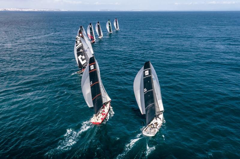 2022 Rolex TP52 World Championship fleet glides downwind under spinnaker photo copyright Kurt Arrigo / Rolex taken at Clube Naval de Cascais and featuring the TP52 class