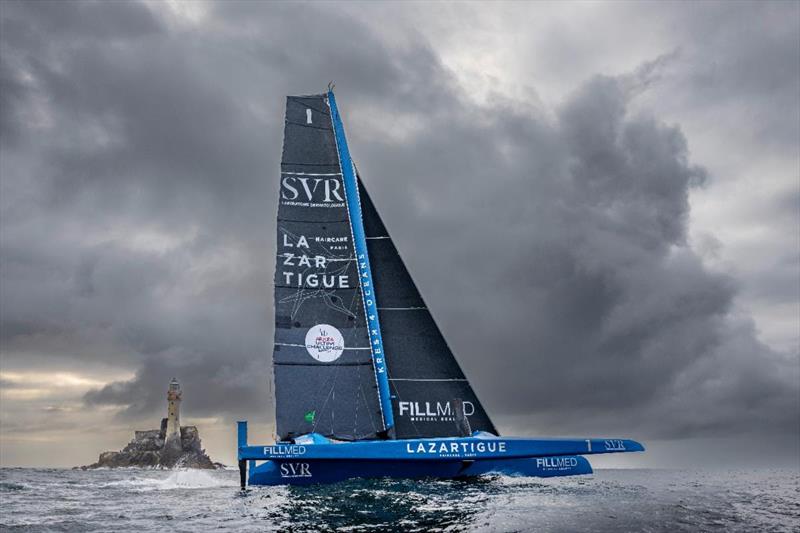 SVR Lazartigue was first to round the Fastnet Rock photo copyright Rolex / Kurt Arrigo taken at Royal Ocean Racing Club and featuring the Trimaran class