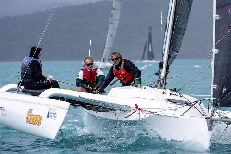 Terry Archer (black hood with blue top jacket) at the helm of his G'Nome at Airlie Beach Race Week - photo © Andrea Francolini, ABRW