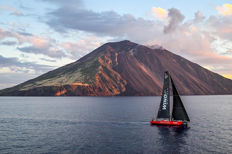 The Polish crewed VO65 Wind Whisper passes the active volcano that is Stromboli during the 2025 race - photo © Kurt Arrigo / Rolex