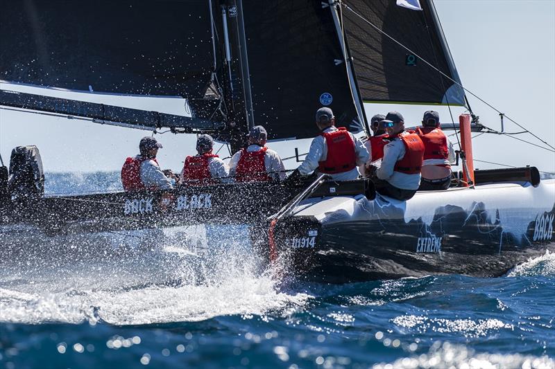 Back in Black at speed - Airlie Beach Race Week 2019 photo copyright Andrea Francolini taken at Whitsunday Sailing Club and featuring the Extreme 40 class