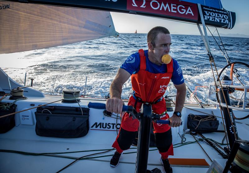 Nick Dana enjoys a peach while grinding onboard Vestas 11th Hour Racing photo copyright James Blake / Volvo Ocean Race taken at  and featuring the Volvo One-Design class
