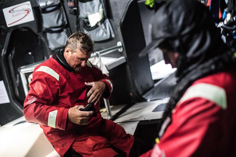 Leg 3, Cape Town to Melbourne, day 13, John Fisher removes his gloves after a cold and wet watch on board Sun Hung Kai / Scallywag photo copyright Konrad Frost / Volvo Ocean Race taken at  and featuring the Volvo One-Design class