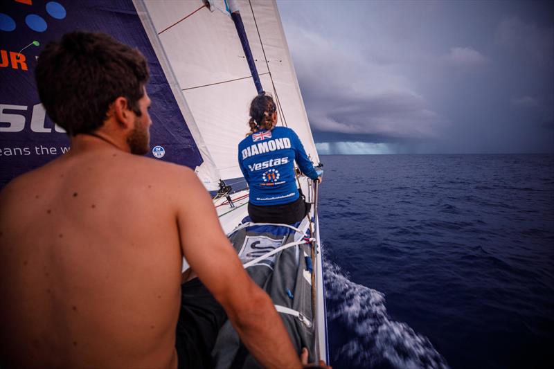 Leg 4, Melbourne to Hong Kong, day 11, Hannah Diamond sits on the rail while waiting for whatever trickery the looming rain cloud has in store while on board Vestas 11th Hour photo copyright Amory Ross / Volvo Ocean Race taken at  and featuring the Volvo One-Design class