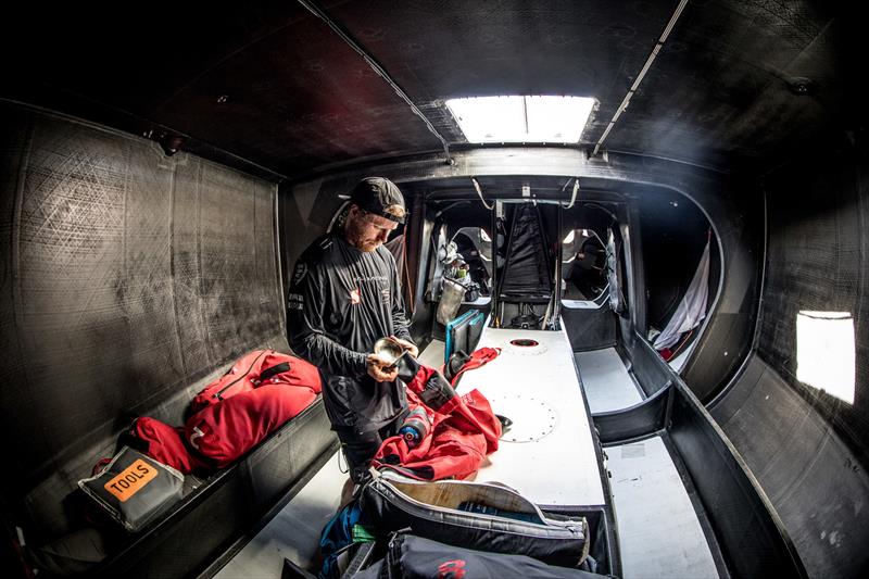 Leg 4, Melbourne to Hong Kong, day 11 Luke Parkinson repairing a seal on his jacket. Not needed now but the forecast has much wetter conditions in the coming week on board Sun Hung Kai / Scallywag photo copyright Konrad Frost / Volvo Ocean Race taken at  and featuring the Volvo One-Design class