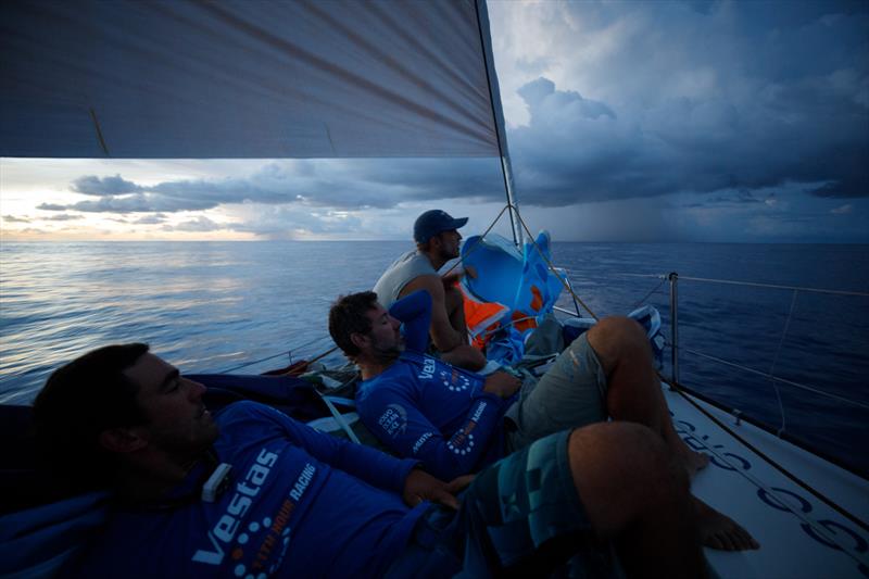 Leg 4, Melbourne to Hong Kong, day 11, rain clouds line the horizon at sundown while Nick Dana, Simon Fisher `SiFi` and Mark Towill await their influences on board Vestas 11th Hour photo copyright Amory Ross / Volvo Ocean Race taken at  and featuring the Volvo One-Design class