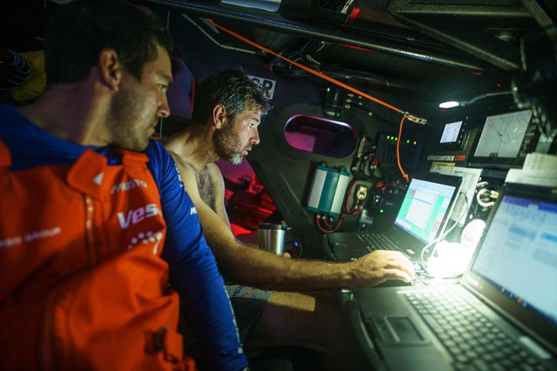 Leg 4, Melbourne to Hong Kong, day 14, navigator Simon Fisher \'SiFi\' and Mark Towill discuss the latest position report in the nav station on board Vestas 11th Hour - photo © Amory Ross / Volvo Ocean Race