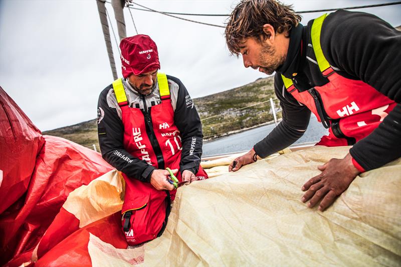 Leg 7 from Auckland to Itajai, day 12 on board MAPFRE, Xabi Fernadez cutting a piece of 3Di from the sail A3 with the help of Guillermo Altadill to repair the main sail, 29 March, . - photo © Ugo Fonolla / Volvo Ocean Race
