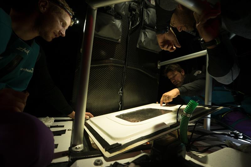 Leg 7 from Auckland to Itajai, day 16 on board AkzoNobel. 01 April, . Nicolai Sehested, Simeon Tienpoint and Jules Salter inspect the keel wetbox lid. - photo © James Blake / Volvo Ocean Race