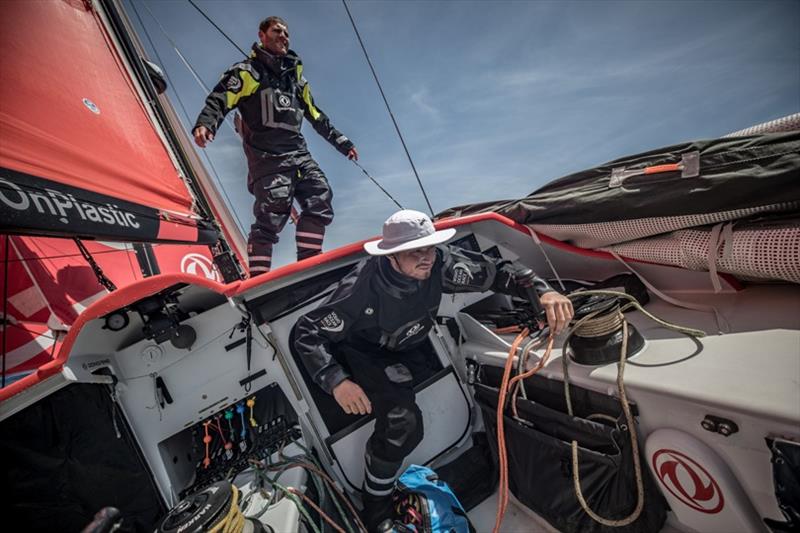 Volvo Ocean Race Leg 8 from Itajai to Newport, day 15, on board Dongfeng. Charles Caudrelier stacking while Jackson gets out of the hatch, ready to help photo copyright Jeremie Lecaudey / Volvo Ocean Race taken at  and featuring the Volvo One-Design class