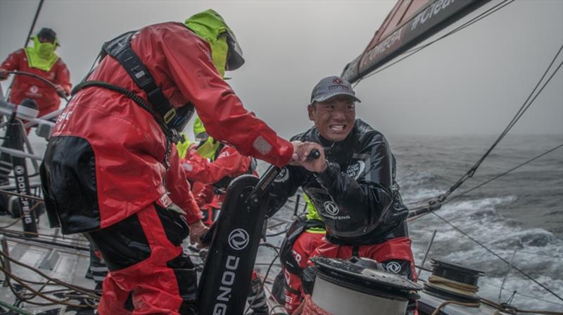 Volvo Ocean Race Leg 9, from Newport to Cardiff, day 01, on board Dongfeng. Horace grinding hard a few hours after the start photo copyright Jeremie Lecaudey / Volvo Ocean Race taken at  and featuring the Volvo One-Design class