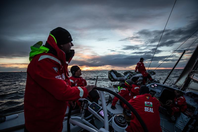 Leg 11, from Gothenburg to The Hague, day 1 on board Sun Hung Kai / Scallywag. 'Snakes and ladders' David Witt on the wheel as the sun sets on the first night. 21 June,  photo copyright Konrad Frost / Volvo Ocean Race taken at  and featuring the Volvo One-Design class