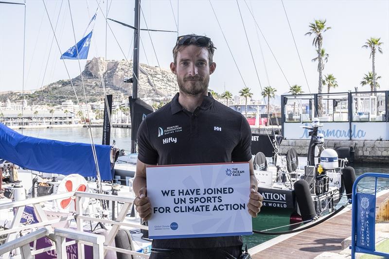 Olly Young from Mirpuri Foundation Racing Team with the UN Sports for Climate Action sign photo copyright Cherie Bridges / The Ocean Race taken at  and featuring the Volvo One-Design class