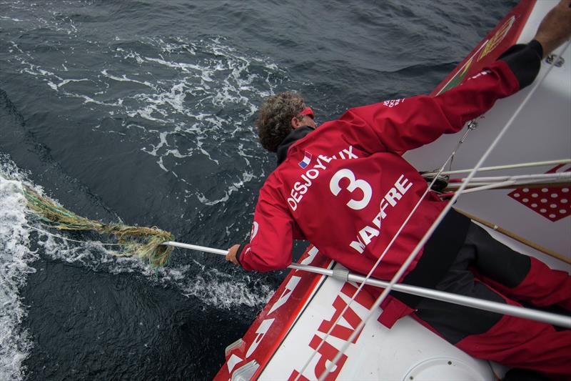 November 01,2014. Leg 1 onboard MAPFRE. Michel Desjoyeaux just after taking out the fishing net from the rudder photo copyright Francisco Vignale / Volvo AB taken at  and featuring the Volvo One-Design class