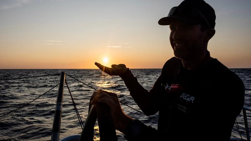 The Ocean Race VO65 Sprint Cup 2022-23 - 21 June 2023, Stage 3, Day 6 onboard Viva México. Brad Marsh hold's the sun in the palm of his hand photo copyright Jen Edney / Viva México / The Ocean Race taken at  and featuring the Volvo One-Design class