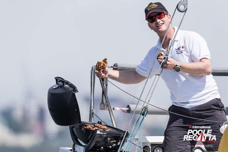 Ed Wilton barbeques while helming on Tom Tit during the International Paint Poole Regatta 2018 photo copyright Ian Roman / International Paint Poole Regatta taken at  and featuring the VPRS class