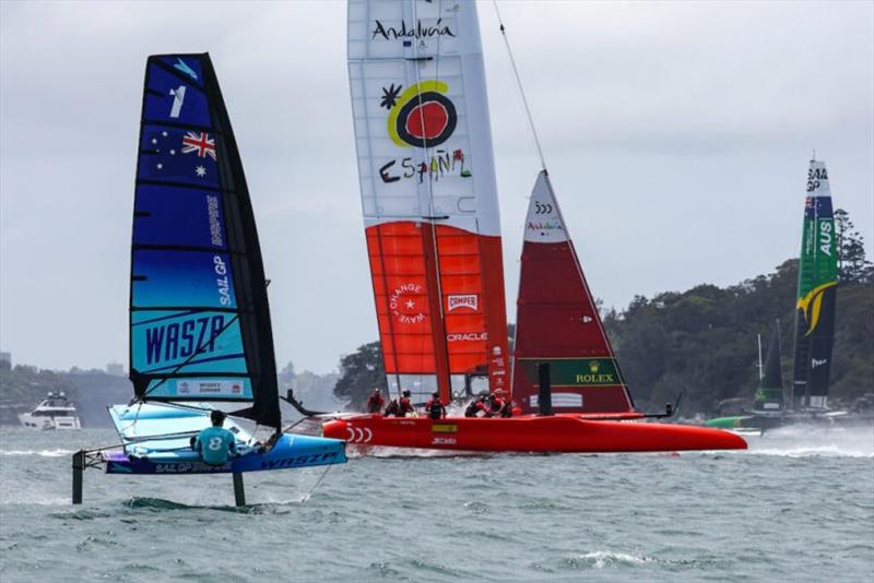 Young sailors sail pass Spain SailGP Team co-helmed by Florian Trittel and Phil Robertson as they take part in the Inspire Racing x WASZP program. Australia Sail Grand Prix presented by KPMG. 16 December 2021 photo copyright Patrick Hamilton for SailGP taken at  and featuring the WASZP class