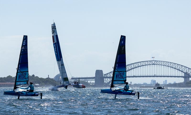 Young sailors takes part in the Inspire Racing x WASZP program. As France SailGP Team comes in the middle. With The Sydney Harbour Bridge in the background. Ahead of the KPMG Australia Sail Grand Prix in Sydney, Australia. Friday 17th February 2023 photo copyright Chloe Knott for SailGP taken at  and featuring the WASZP class