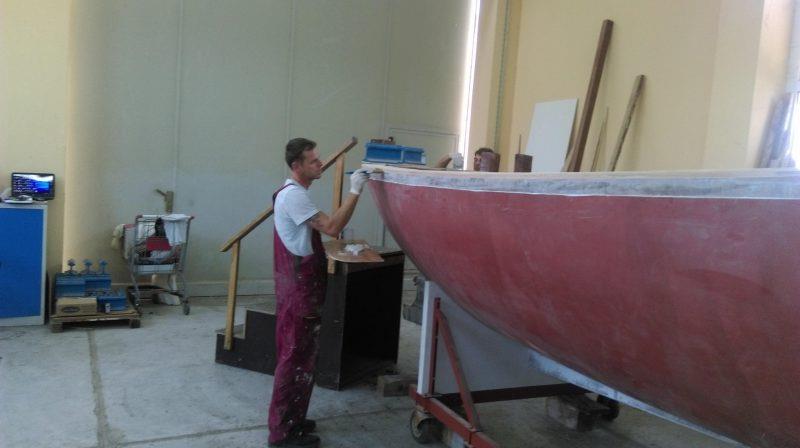 A craftsman applies epoxy to the exposed grain of the deck plywood to ensure it is fully sealed photo copyright Wessex Resins & Adhesives taken at  and featuring the  class