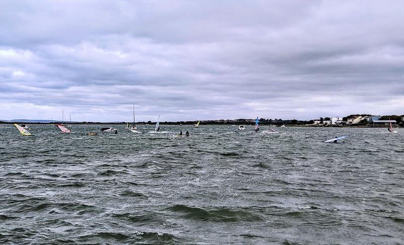 Christchurch harbour packed with windsurfers on Saturday photo copyright Mark Jardine taken at  and featuring the Windsurfing class