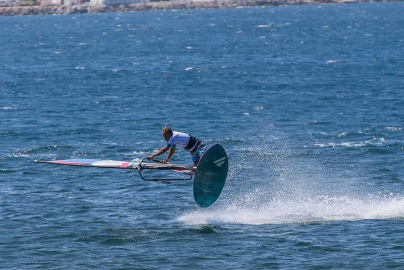 Once in the air, stay over your sail, pushing down with both hands photo copyright Tricktionary taken at  and featuring the Windsurfing class