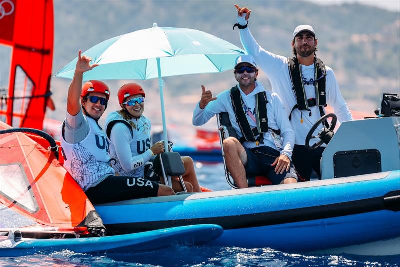 Team USA Windsurfers Noah Lyons (Clearwater, FL) and Dominique Stater (Miami, FL) keep out of the sun with coaches Juanma Moreno and Pedro Pascual while on wind delay. Men's and Women's Windsurfing did not race today due to light winds - photo © Sailing Energy / US Sailing Team