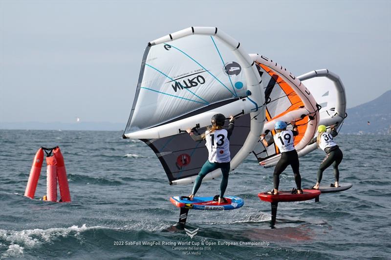 Close racing in the women's fleet with Ceris Orane (No.13) chasing Margherita Barro (No.19) and Ellie Aldridge (No. 30) - SabFoil 2022 WingFoil Racing World Cup & Open Europeans, Day 2 photo copyright IWSA Media / Markus Schwendtner taken at Campione Univela and featuring the Wing Foil class