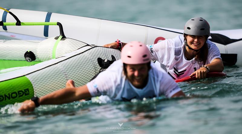 Francesco Cappuzzo and Maddalena Spanu swim back in no wind - 2024 WingFoil Racing World Cup Turkiye day 1 - photo © IWSA media / Robert Hajduk